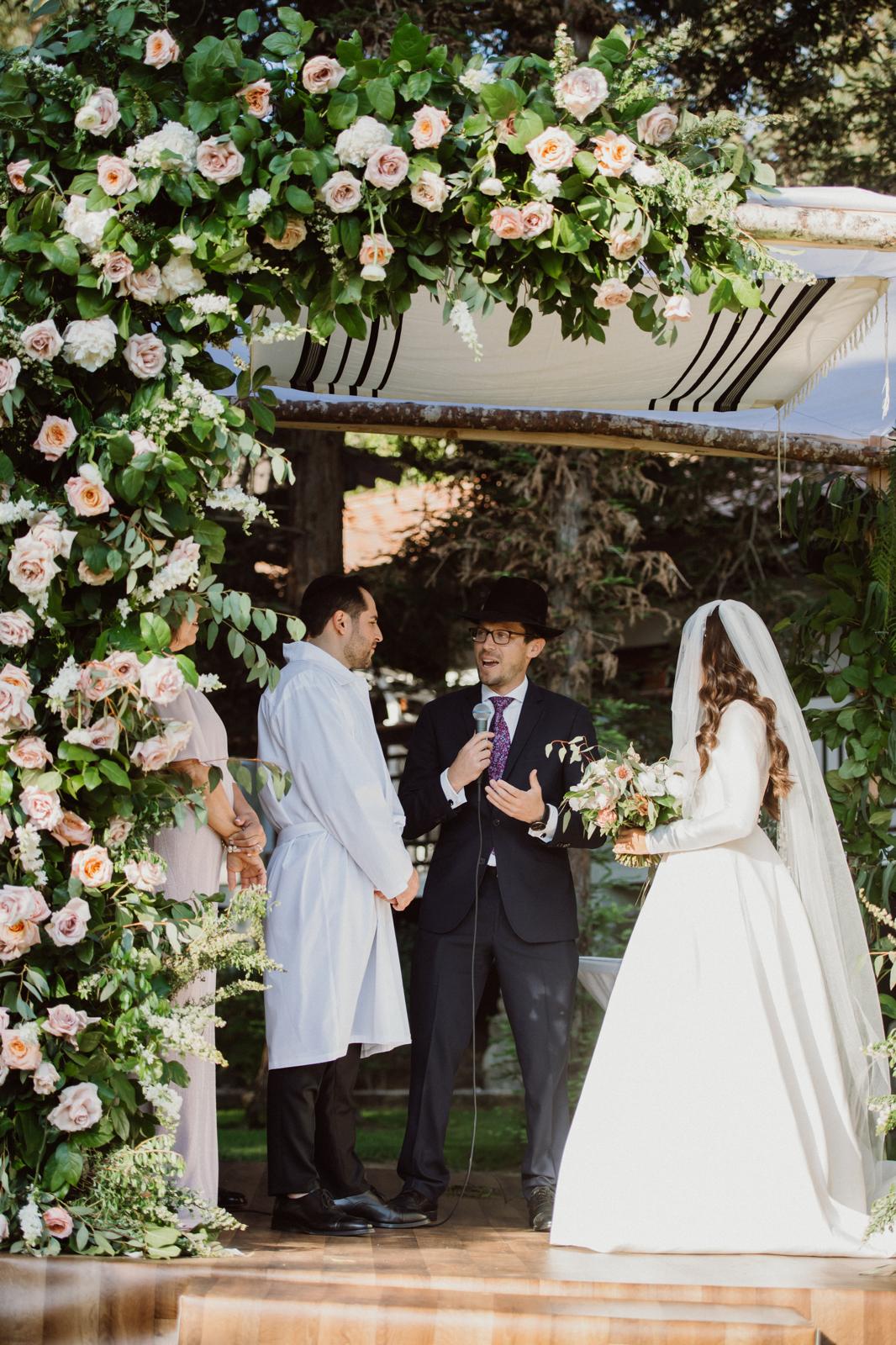Under the chuppah, officiated by Rabbi Mordechai Teller.